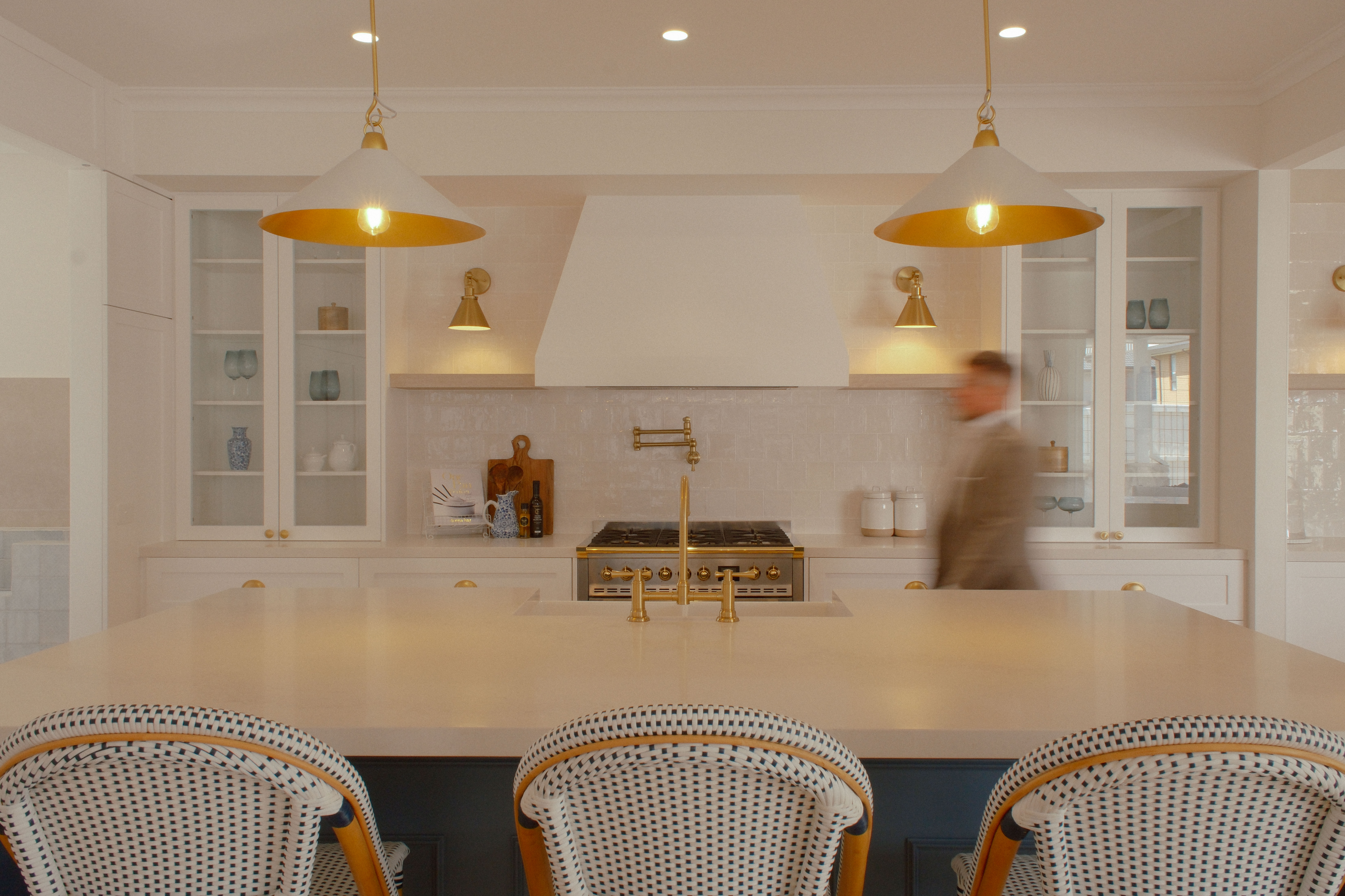 Finished turnkey kitchen interior with brass pendant lighting and island bench